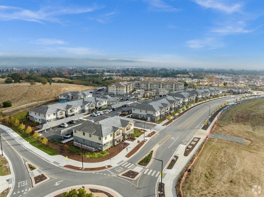an aerial view of a city with a highway and buildings