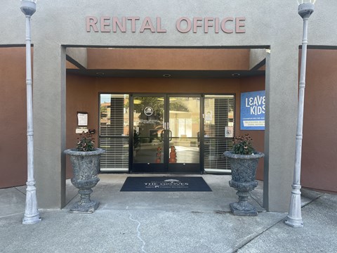 A rental office building with a sign that says "Leave Kids" on the door.