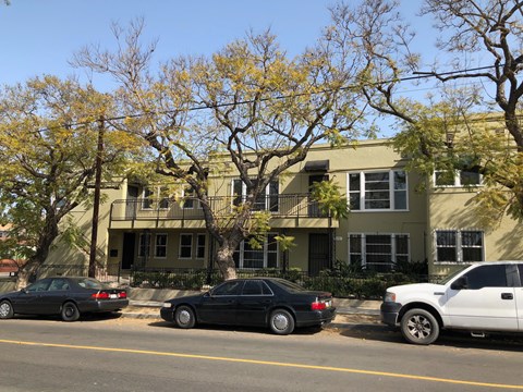 an apartment building with cars parked in front of it