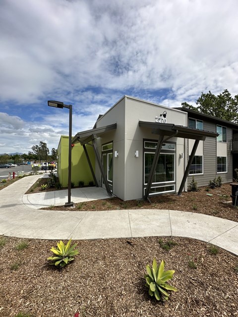 A modern house with a grey and green exterior.