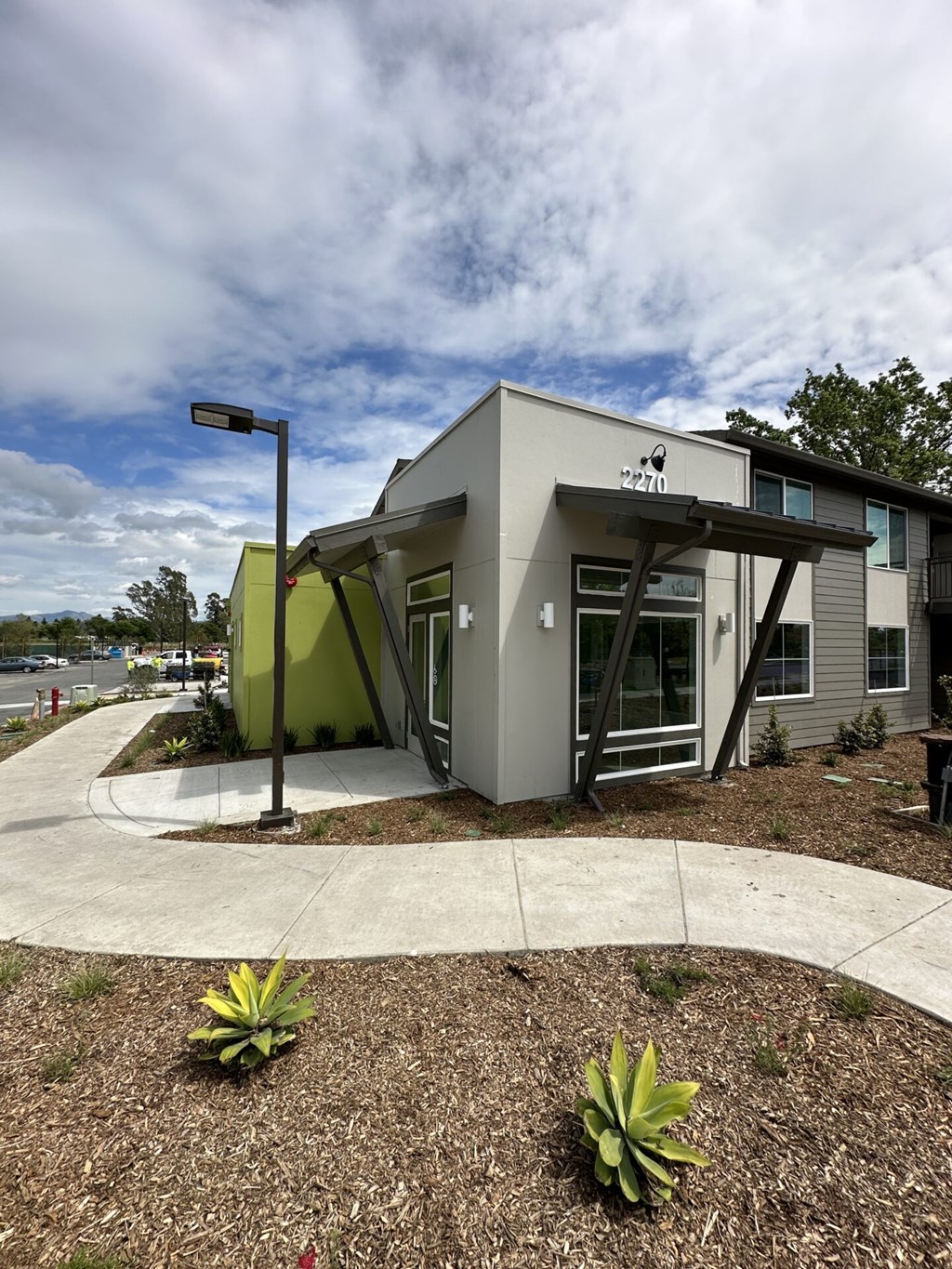 A leasing office with a grey exterior and a green accent wall.