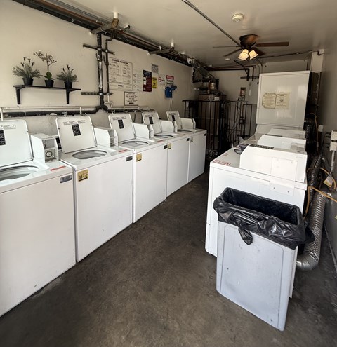 A row of washing machines in a laundromat.