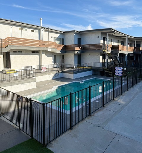 A black fence surrounds a small pool.