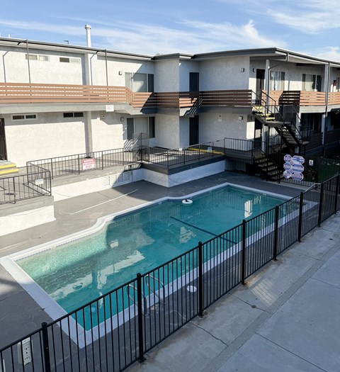 A black fence surrounds a small pool.