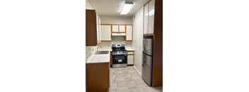 A kitchen with a stove, oven, and refrigerator.