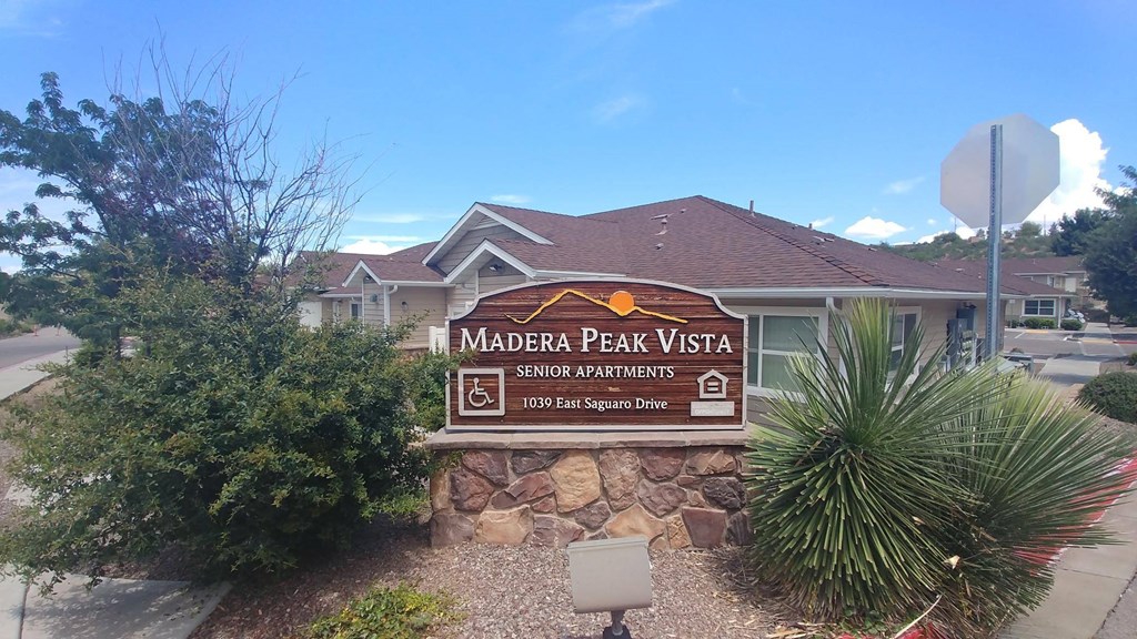 a picture of the madrone peak vista sign with a house in the background