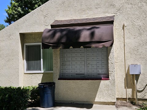 a door to a house with a mailbox and a calendar on it