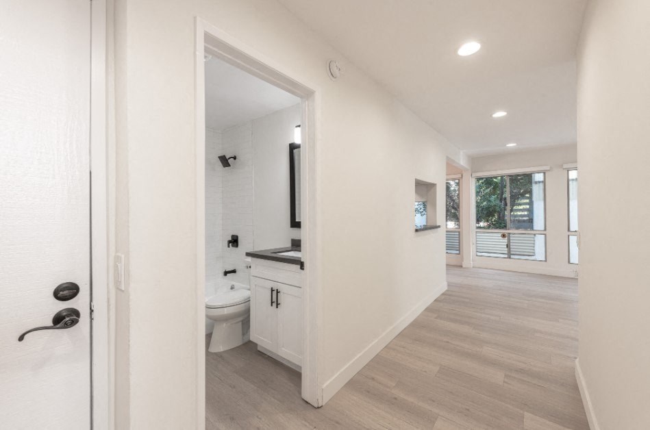 Midvale Apartments Interior back view of Hallway Showing Bathroom on Left to Kitchen/Living Room on Right