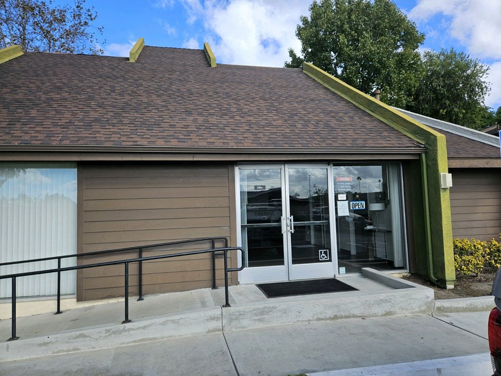 the front entrance of a building with glass doors