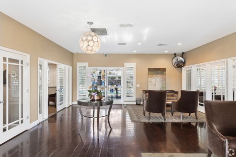 A dining room with a glass table and chairs.