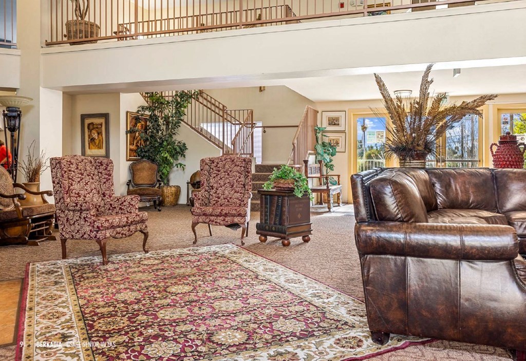 a living room filled with furniture and a large rug