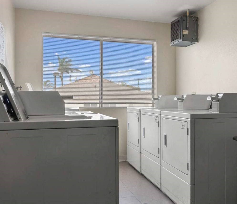 a washer and dryer in a room with a large window