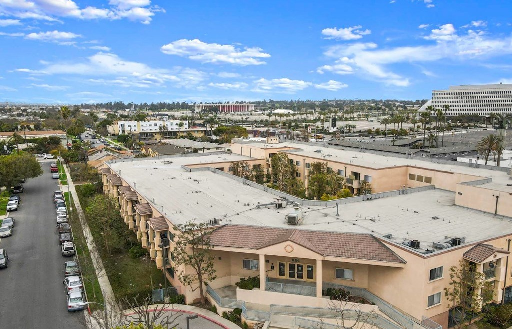 a building with a large roof and a city in the background