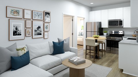 A modern living room with a white couch and a coffee table.