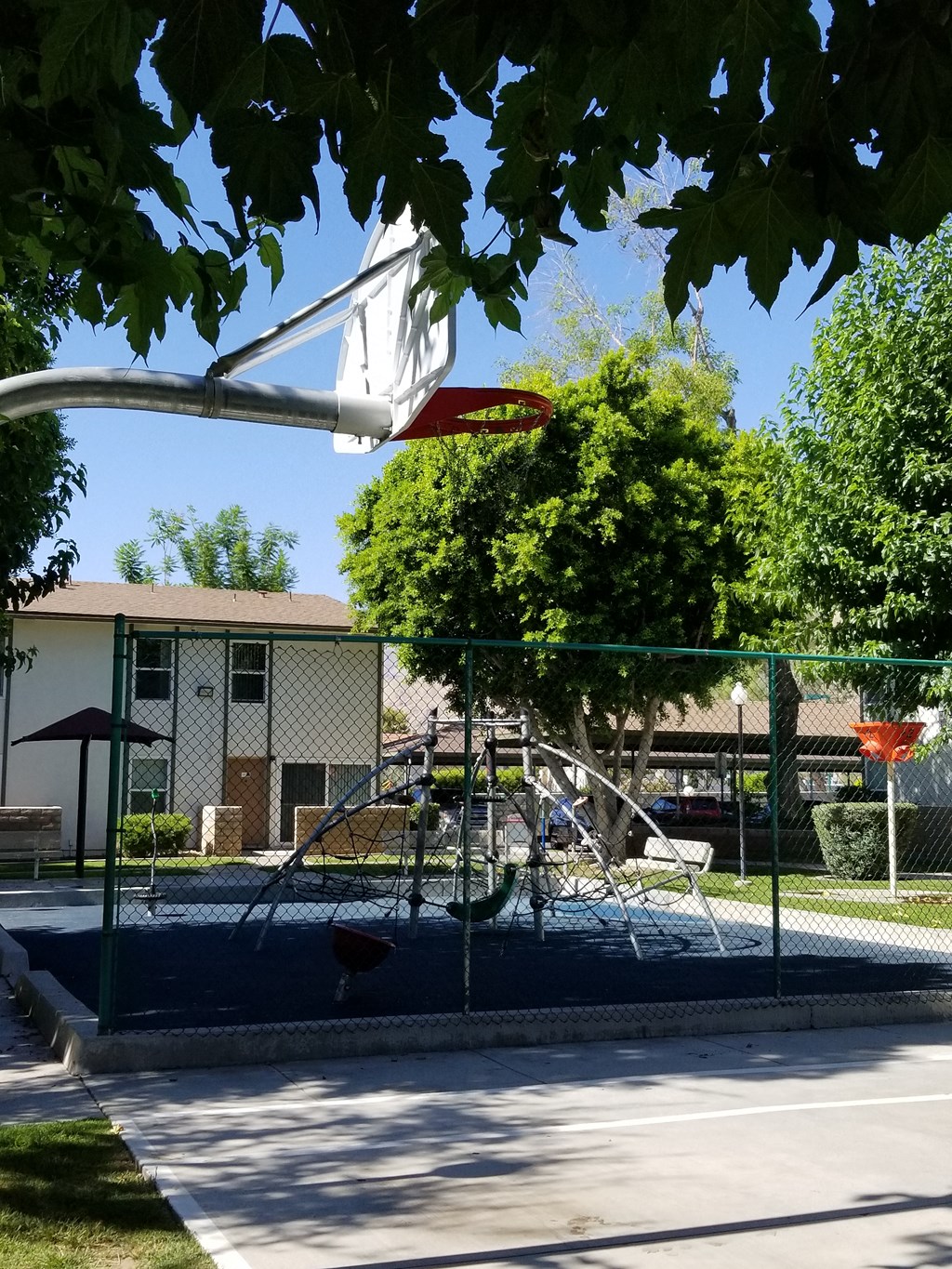a playground with a swing set in front of a building