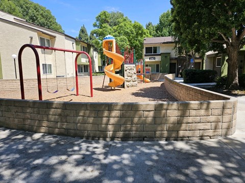 a playground with a slide in a park