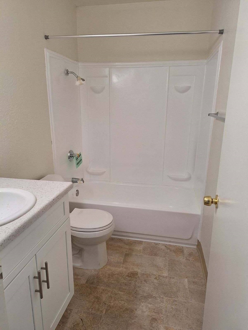 a bathroom with a toilet and a tub and a sink