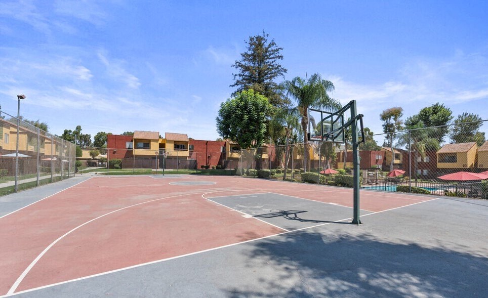 a basketball court in a park with apartments in the backgroundat Brookhollow Apartments, West Covina , CA 91792