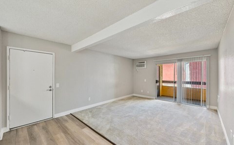 the spacious living room with sliding glass doors to the balcony