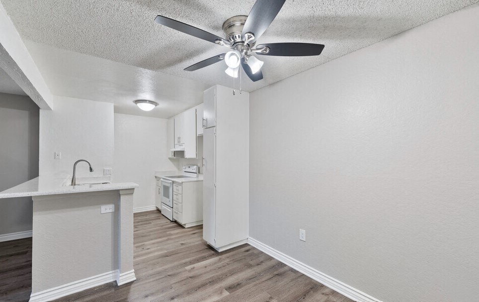 an open kitchen and living room with a ceiling fan at Brookhollow Apartments, West Covina , California