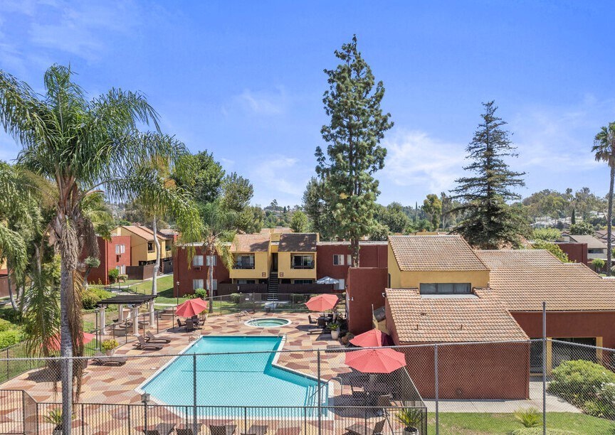 an aerial view of a resort with a pool and umbrellas at Brookhollow Apartments, California, 91792