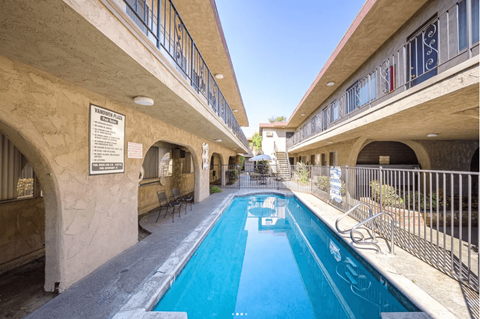 A pool in a building with a sign on the wall.
