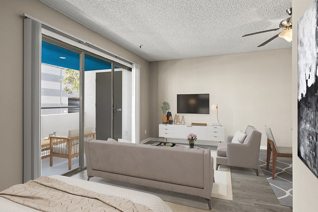 A modern living room with a grey sofa and a television in studio apartment at Harbor Terrace Apartments, California, 90731