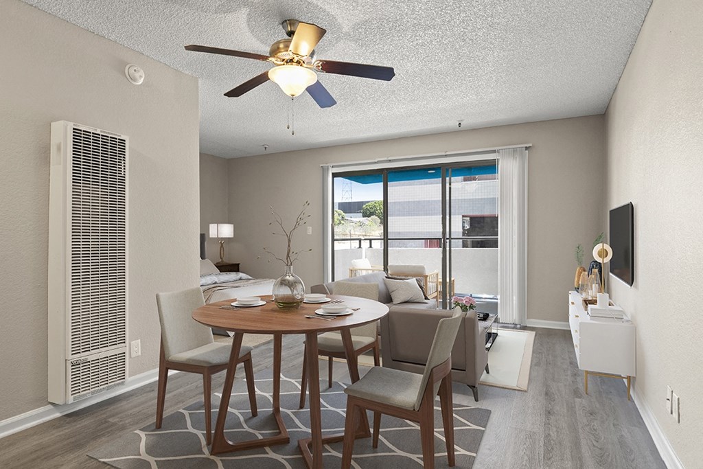 A dining room with a table set for two and a ceiling fan in a studio apartment at Harbor Terrace Apartments, California, 90731