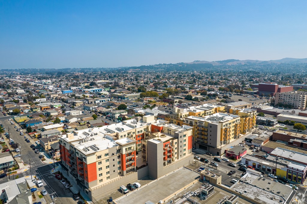 A cityscape with buildings and roads under a clear sky.