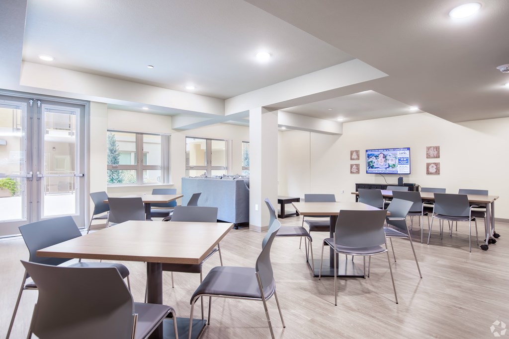 A conference room with a long table and chairs.
