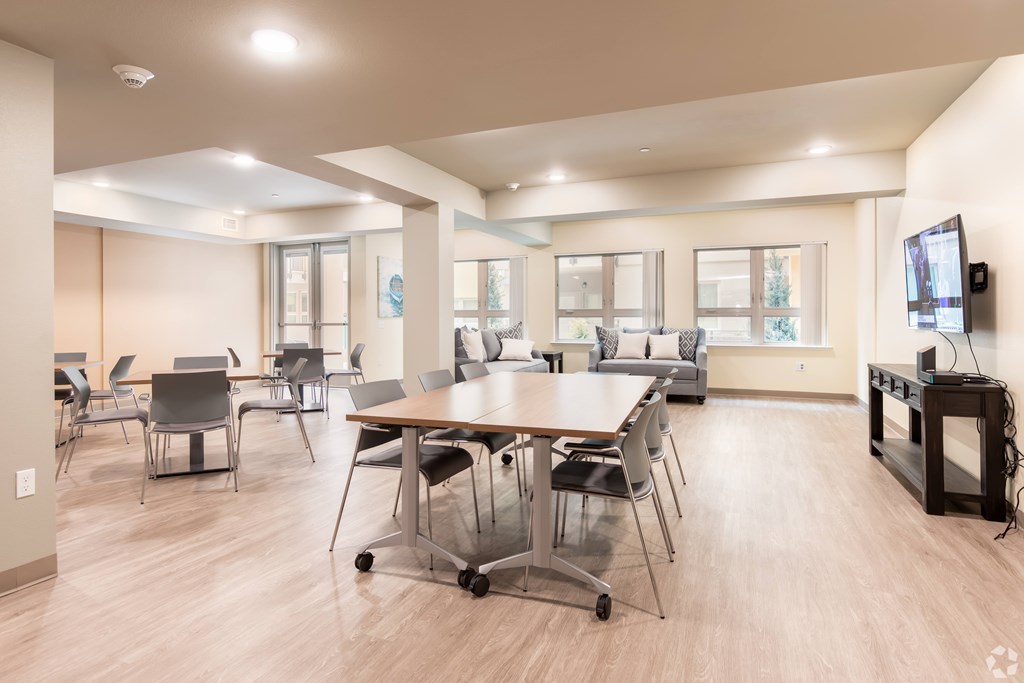 A conference room with a long table and chairs.