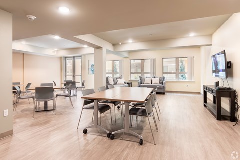 A conference room with a long table and chairs.