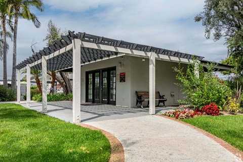 A house with a covered patio and a walkway leading to it at The Arbors Santa Ana, California, 92705