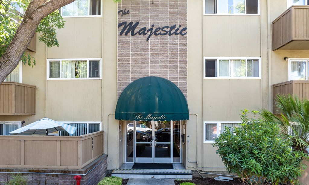 the entrance to the majestic building with a green awning