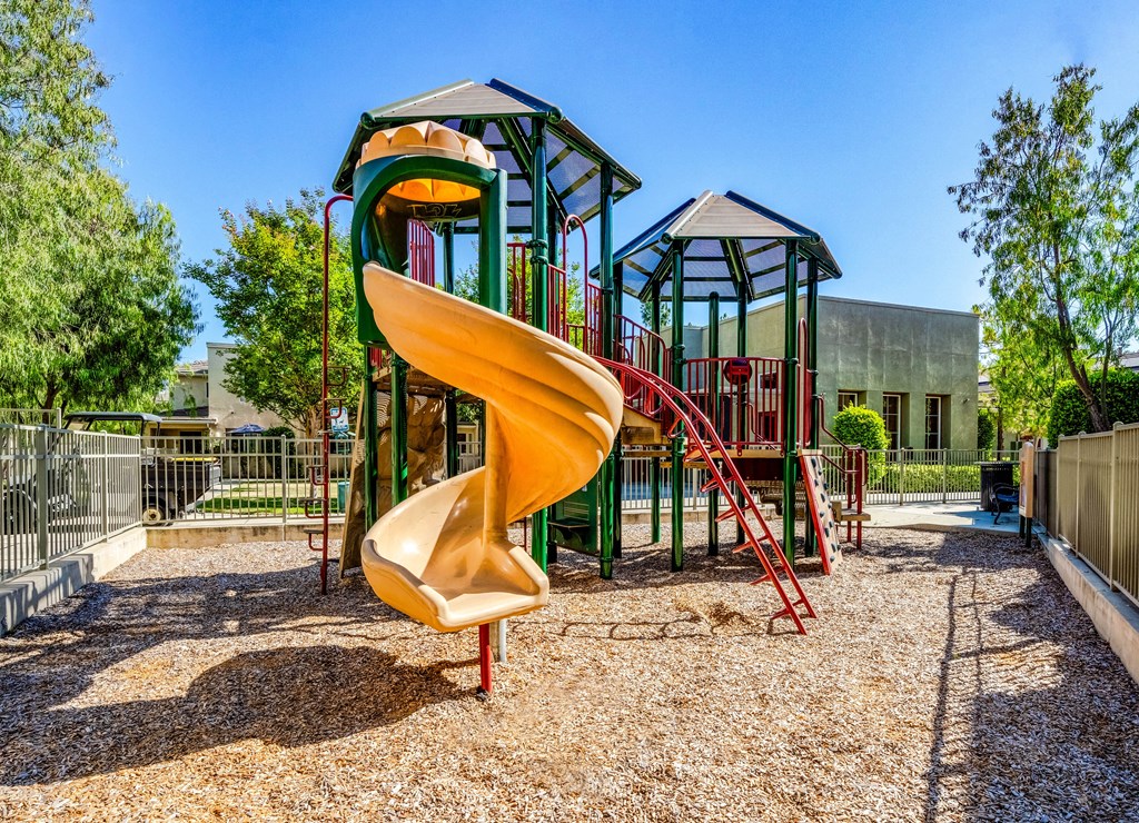 the playground at the  apartments with a slide