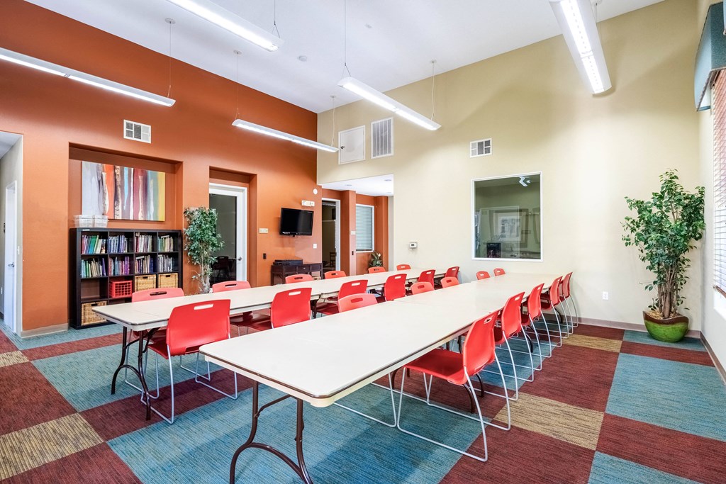 a large conference room with a long table and chairs