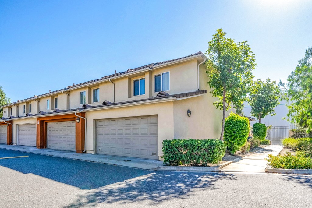 a white house with a garage door and a driveway