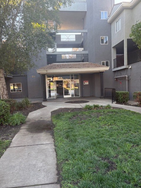A building with a brown roof and a glass door.