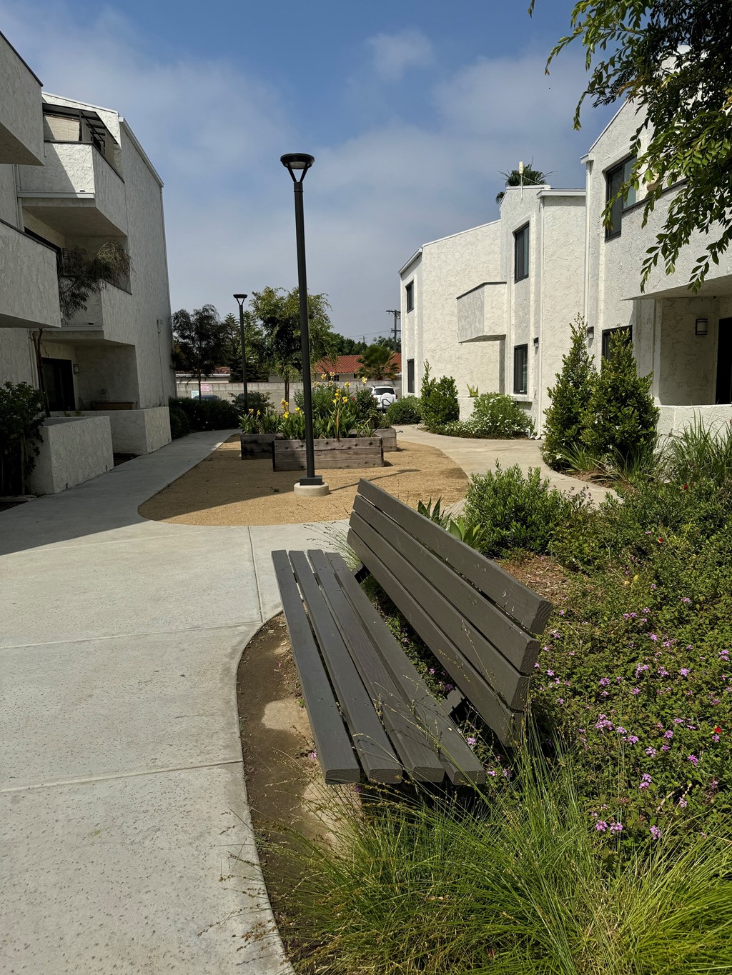 a bench on a sidewalk in front of some buildings