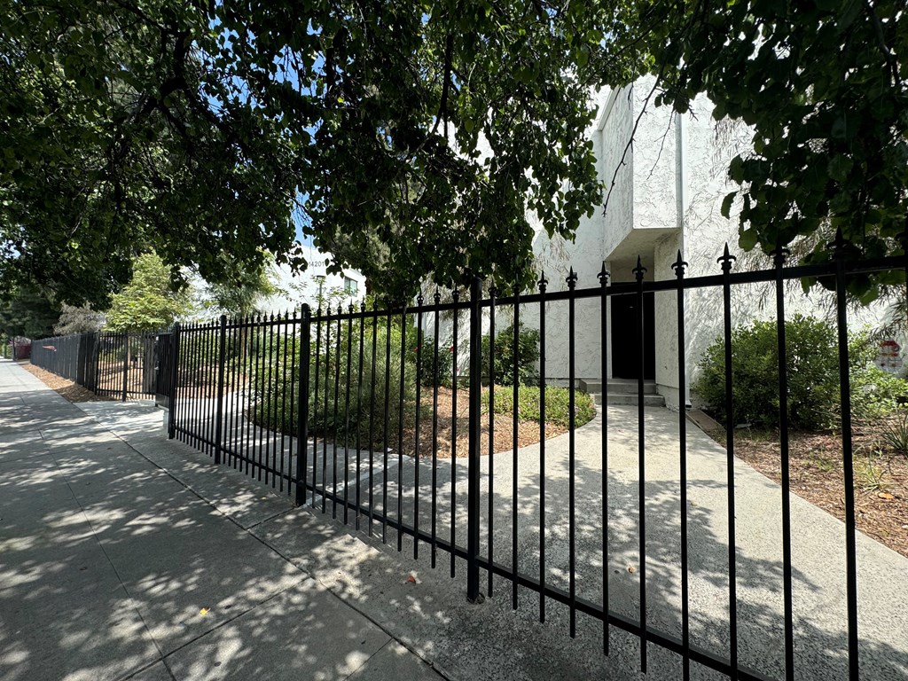 a black iron fence in front of a building