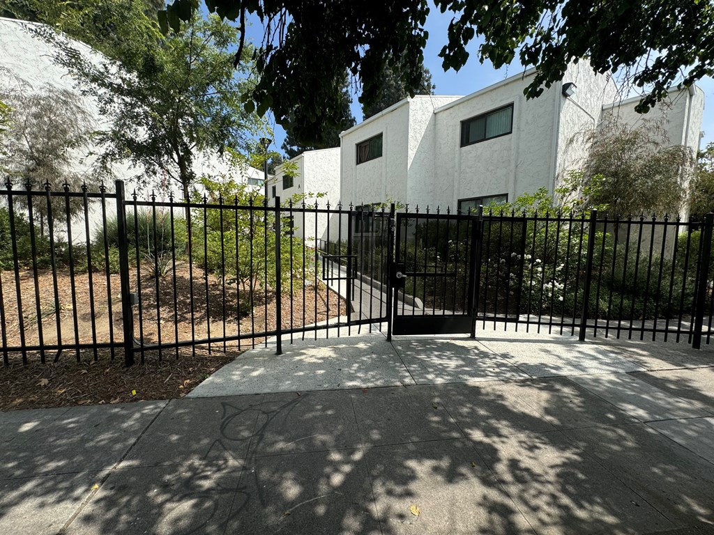 an image of an apartment building behind a fence