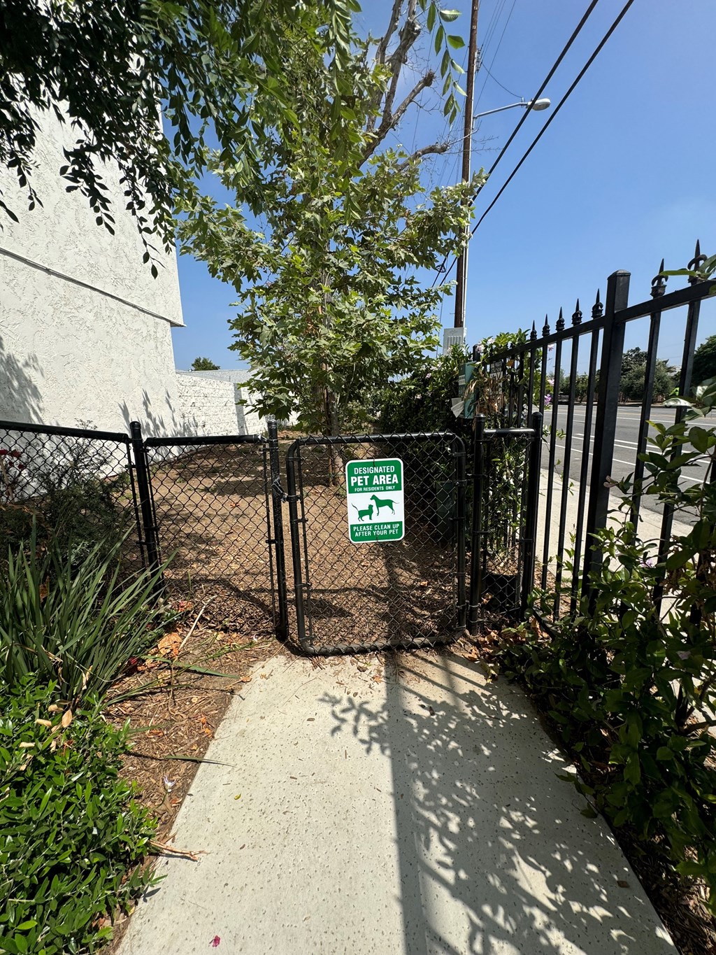 a gate with a sign on it in front of a fence