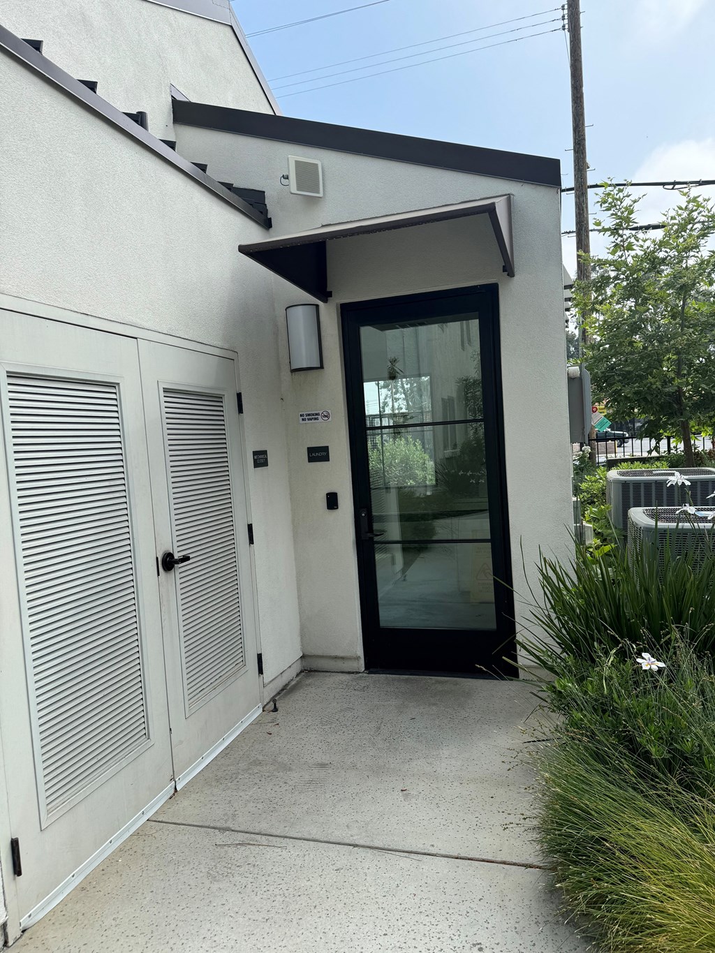 the front entrance of a laundry room with a glass door