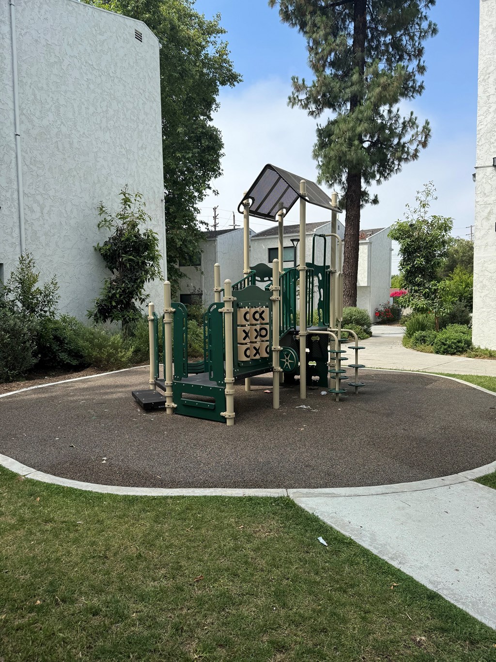 a playground in a yard in front of a building