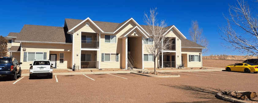 a large apartment complex with a parking lot