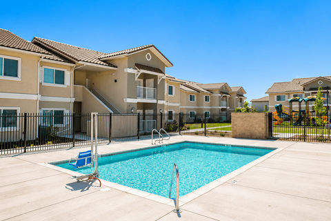 A swimming pool in front of a residential building.