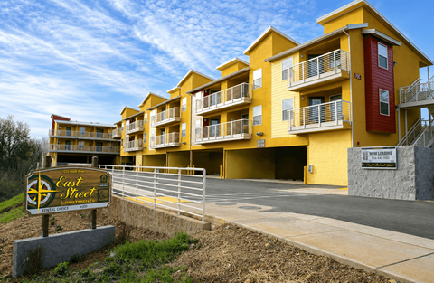 A yellow building with a sign that says "Eastwood" in front of it.
