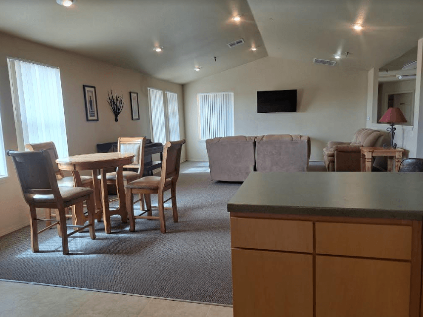 a community room with a couch and a table with chairs