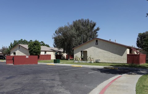 a white house with a red fence and a street