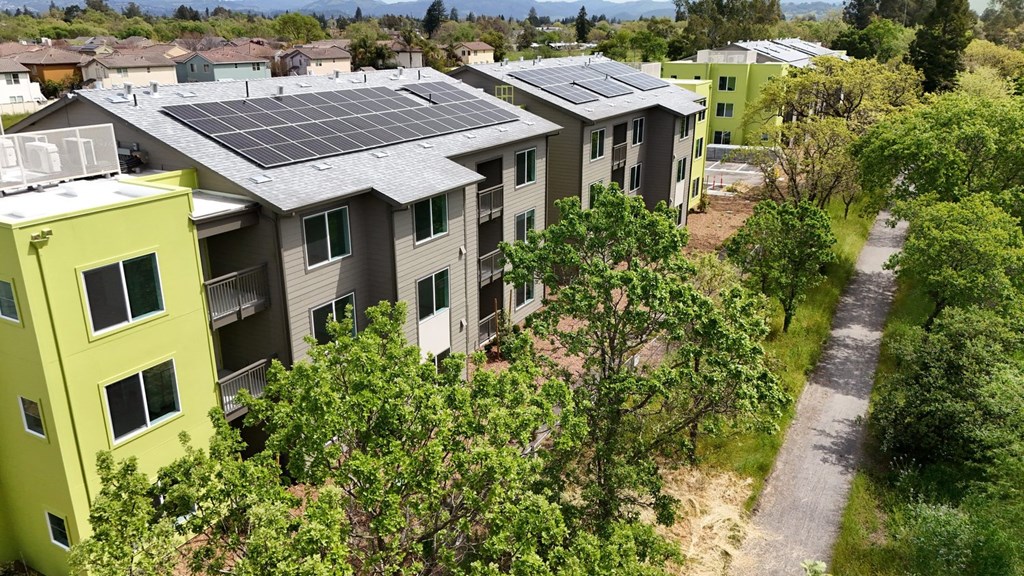 Apartment complex with solar panels on the roof.